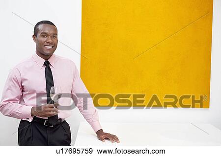 Portrait of smiling young man in front of painting View Large Photo Image Stock Photo - Portrait of smiling young man in front of painting. Fotosearch