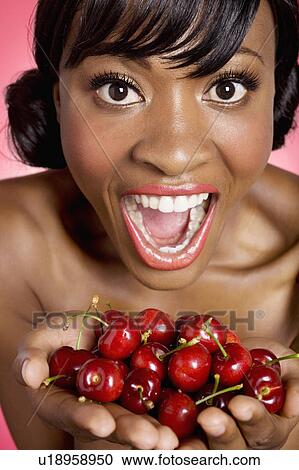 Portrait of woman with hands full of cherries View Large Photo Image Stock Image - Portrait of woman with hands full of cherries. Fotosearch