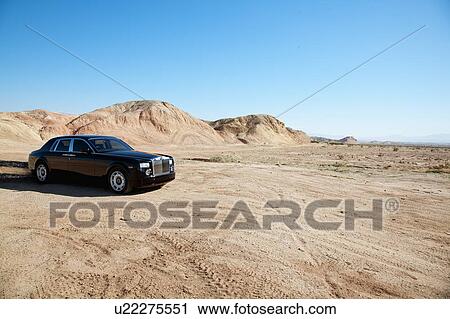 Rolls Royce car leaving trail of black oil behind on unpaved road View Large Photo Image Stock Image - Rolls Royce car leaving trail of black oil behind on unpaved road. Fotosearch