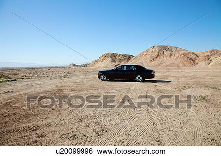 Rolls Royce car parked on unpaved road with tire tracks View Large Photo Image Stock Photograph - Rolls Royce car parked on unpaved road with tire tracks. Fotosearch