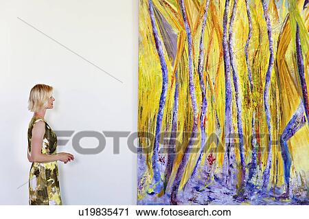 Senior woman looking at painting View Large Photo Image Stock Image - Senior woman looking at painting. Fotosearch