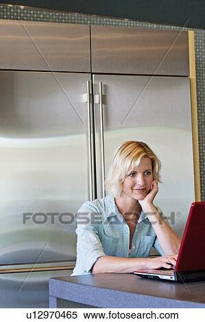 Senior woman with hand on chin using laptop View Large Photo Image Stock Photography - Senior woman with hand on chin using laptop. Fotosearch