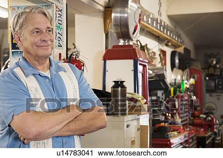 Smiling senior man in automobile workshop View Large Photo Image Stock Image - Smiling senior man in automobile workshop. Fotosearch