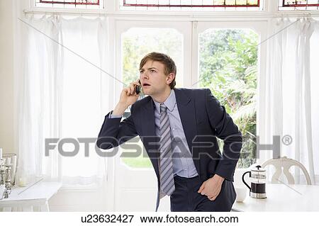 Surprised business man on call View Large Photo Image Stock Photo - Surprised business man on call. Fotosearch
