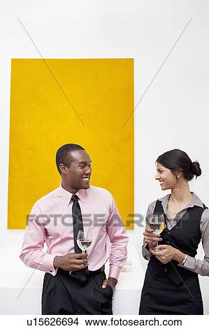 Two young executives in front of yellow painting View Large Photo Image Picture - Two young executives in front of yellow painting. Fotosearch