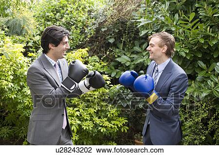 Two young men in suits stage a mock boxing match View Large Photo Image Stock Image - Two young men in suits stage a mock boxing match. Fotosearch