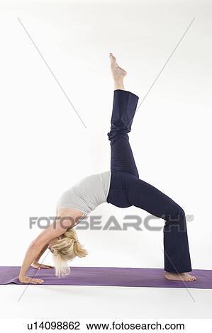Woman bending her back and stretching her leg View Large Photo Image Stock Image - Woman bending her back and stretching her leg. Fotosearch