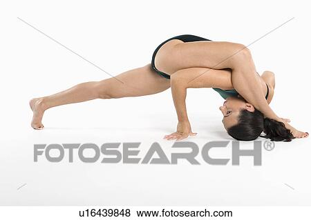Stock Photo - Woman exercising over white background. Fotosearch