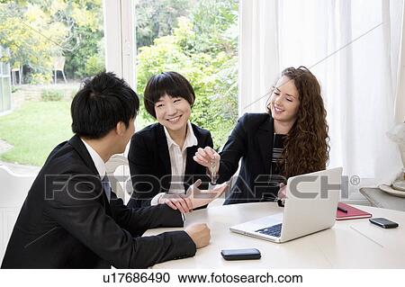 Stock Image - Woman handing over keys to man. Fotosearch