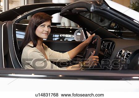 Stock Photo - Woman having a test drive. Fotosearch