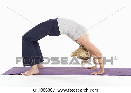 Stock Photo - Woman in backbend yoga pose. Fotosearch