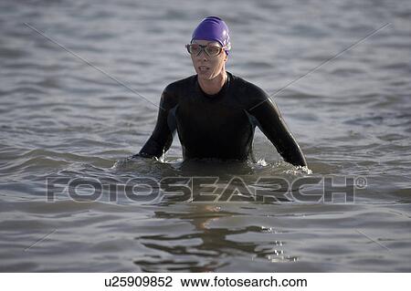 Woman in wetsuit in water View Large Photo Image Stock Image - Woman in wetsuit in water. Fotosearch