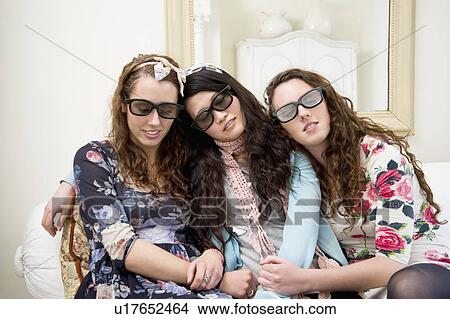Picture - Women sleeping on sofa while wearing sunglasses. Fotosearch