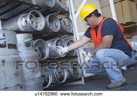 Worker checking the pressure of cylinder View Large Photo Image Stock Image - Worker checking the pressure of cylinder. Fotosearch