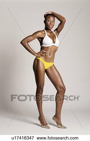 Young African American woman posing colored background View Large Photo Image Stock Photo - Young African American woman posing colored background. Fotosearch