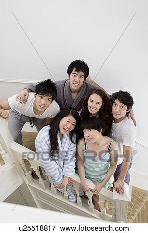 Young friends posing on stairway View Large Photo Image Stock Photo - Young friends posing on stairway. Fotosearch