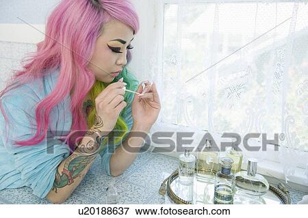 Young woman applying nail polish View Large Photo Image Stock Photo - Young woman applying nail polish. Fotosearch
