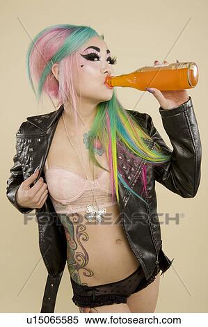 Stock Photography - Young woman drinking juice from bottle. Fotosearch