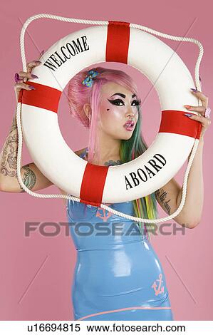 Young woman holding float tube over pink background View Large Photo Image Stock Photography - Young woman holding float tube over pink background. Fotosearch
