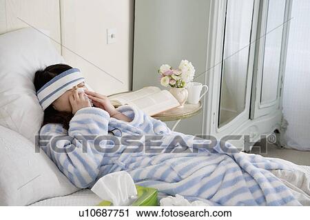 Stock Image - Young Woman Sick in Bed. Fotosearch