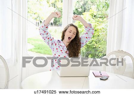 Stock Photography - Young woman yawning. Fotosearch