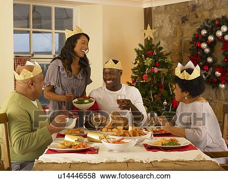 Stock Photo - Adult African American family having Christmas dinner. Fotosearch