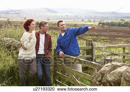 Stock Image - Adult group in countryside. Fotosearch
