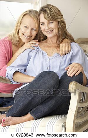 Stock Image - Adult mother and daughter at home. Fotosearch