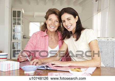 Adult mother and daughter scrapbooking View Large Photo Image Stock Photograph - Adult mother and daughter scrapbooking. Fotosearch