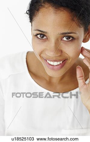 Stock Image - Attractive young woman smiling. Fotosearch