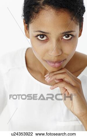 Stock Image - Attractive young woman thinking. Fotosearch