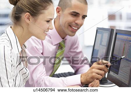 Businessman and woman working on computers View Large Photo Image Picture - Businessman and woman working on computers. Fotosearch