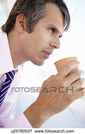 Stock Photo - Businessman drinking coffee. Fotosearch