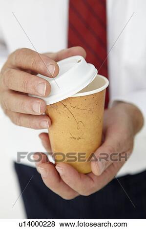 Stock Photo - Businessman holding takeout coffee. Fotosearch