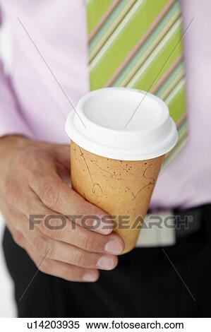Stock Photography - Businessman holding takeout coffee. Fotosearch