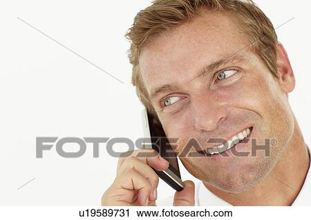Businessman talking on phone View Large Photo Image Stock Image - Businessman talking on phone. Fotosearch