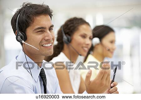 Stock Image - Businessman wearing headset. Fotosearch