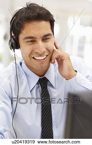 Stock Photo - Businessman wearing headset. Fotosearch