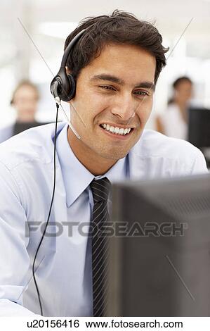Stock Photograph - Businessman wearing headset. Fotosearch
