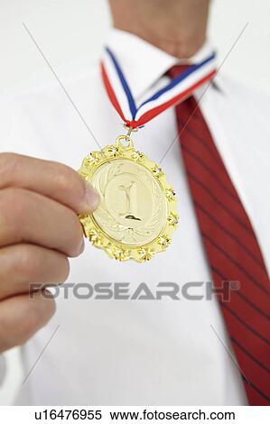 Stock Photography - Businessman wearing medal. Fotosearch