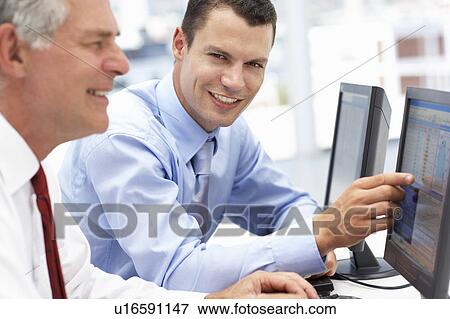 Businessmen working on computers View Large Photo Image Stock Photo - Businessmen working on computers. Fotosearch