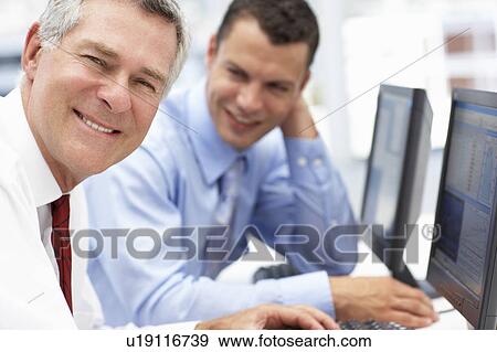 Businessmen working on computers View Large Photo Image Stock Photo - Businessmen working on computers. Fotosearch