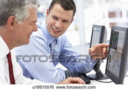Businessmen working on computers View Large Photo Image Stock Photograph - Businessmen working on computers. Fotosearch