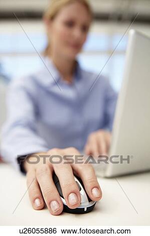 Stock Photograph - Businesswoman using laptop. Fotosearch