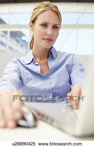 Stock Photography - Businesswoman using laptop. Fotosearch