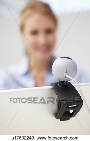 Stock Image - Businesswoman using skype. Fotosearch