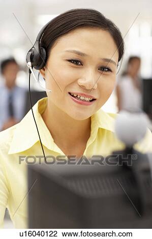 Businesswoman wearing headset View Large Photo Image Stock Image - Businesswoman wearing headset. Fotosearch