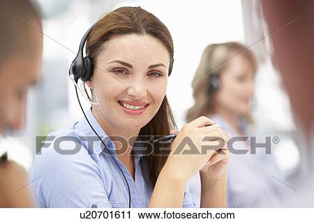 Stock Image - Businesswoman wearing headset. Fotosearch
