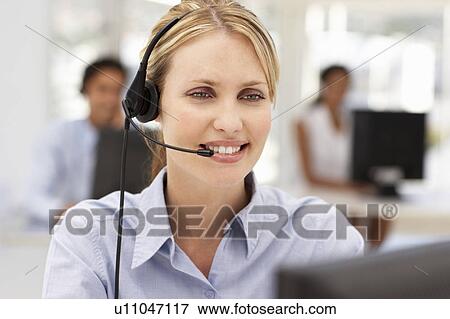 Stock Photo - Businesswoman wearing headset. Fotosearch