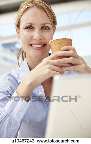 Businesswoman with laptop and coffee View Large Photo Image Stock Image - Businesswoman with laptop and coffee. Fotosearch